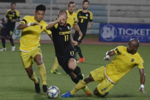 Ceres La Salle FC star Stephan Schrock (center) challenges Global FC defenders Dennis Villanueva (left) and Serge Kaole (right) during their clash in the United Football League on Sunday. UFL MEDIA PHOTO