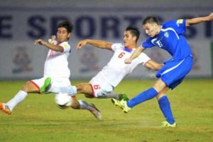 Igor Sergeev (right) of Uzbekistan kicks the ball to score against Luke Woodland (center) and Sato Daisuke (left) of the Philippines during their 2018 World Cup qualifying football match at the Philippine Sports Stadium in Bocaue town, Bulacan province last September 8, 2015.  AFP PHOTO