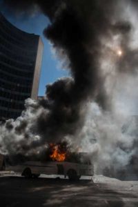 A bus has been set on fire during clashes between students and riot police following a protest over University tuition fees on Monday in Johannesburg. South African student protesters and police clashed in renewed violence in Johannesburg as attempts to re-open Wits University descended into running battles on campus. AFP / MUJAHID SAFODIEN