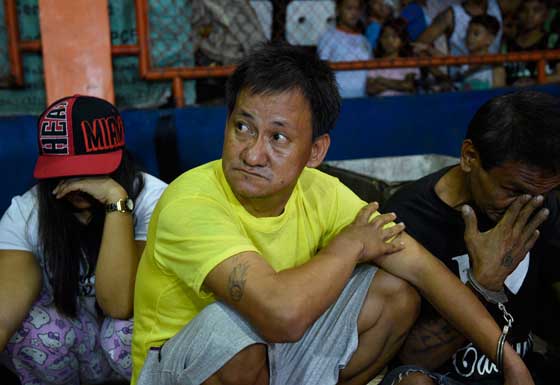 This photo taken last September 30 shows Moises Payawal, No. 5 of the top ten drug personalities on a police watch list, waits to be brought to a police station after a drug buy-bust in Tondo, Manila. President Rodrigo Duterte also on September 30 likened his deadly crime war to Hitler’s efforts to exterminate Jews, as he declared he was “happy to slaughter” millions of drug addicts. AFP PHOTO