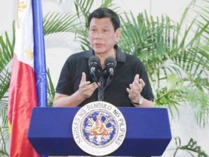 HOME AGAIN President Rodrigo Duterte talks about his trip to Vietnam at the Davao International Airport early Friday. AFP PHOTO