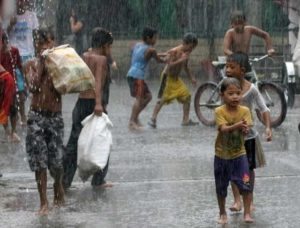 Children play in the rain in Quezon City. Karen ‘slightly intensified’ as it moved away from the country, but not after toppling power lines and causing outages, and forcing the cancellation of 290 flights. PHOTOS BY RUSSELL PALMA AND RUY MARTINEZ