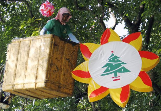 A worker installs huge lanterns on a tree at the Quezon  City Memorial Circle as the country starts preparing for the most festive season.  PHOTO BY MIKE DE JUAN 