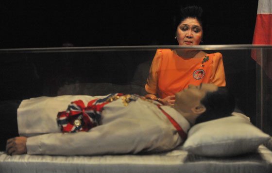 This file photo taken on March 26, 2010 shows former Philippine first lady Imelda Marcos looking at the embalmed body of her husband former leader Ferdinand . AFP Photo