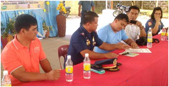 DRUG-FREE Camantiles Barangay Chairman Elmer Gancena (3rd from right) is shown signing the drugfree certification in the presence of (from left) Dexter Asayco of the Philippine Drug Enforcement Agency Region I and Supt. Marceliano Desamito Jr., Urdaneta City acting chief of police. PHOTO BY JAIME G. AQUINO