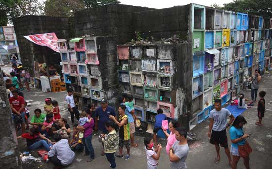 People flock to the Novaliches Public Cemetery in Quezon City on Monday, the eve of the Solemnity or feast of All Saints, November 1, on which Filipinos commemorate the dead. The Catholic liturgical calendar, however, reserves that activity to All Souls’ Day, on November 2. PHOTO BY RUY MARTINEZ