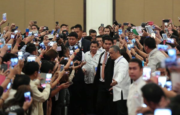 President Rodrigo Duterte is mobbed by mobile-phone-wielding Filipino residents in Phnom Penh, upon his arrival for a state visit to Cambodia on Tuesday. 