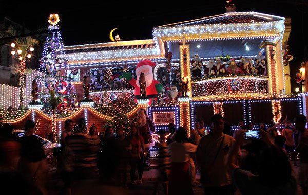  It is full of lights and Santa Clauses, thus this house along Policarpio St. in Mandaluyong City draws dozens of visitors every night. The house has become a tourist attraction in the city every December. PHOTO BY ROGER RAÑADA 