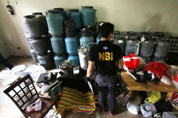 SHABU LAB IN SAN JUAN Agents and chemists of the National Bureau of Investigation make an inventory of chemicals and paraphernalia for making shabu at an apartment on Wilson Street in San Juan. PHOTO BY RUY L. MARTINEZ