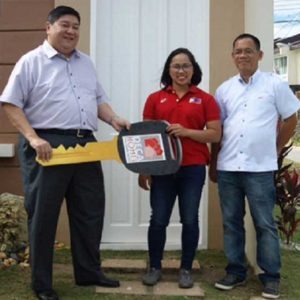 8990 Holdings Inc., Chief Operating Officer Willy Uy (left) and 8990 Holdings Assistant General Manager Nicolas Cruz (right) awards the ceremonial key to Rio Olympics 2016 Silver Medalist Hidilyn Diaz at Deca Clark Resort and Residences in Angeles City, Pampanga.  CONTRIBUTED PHOTO 