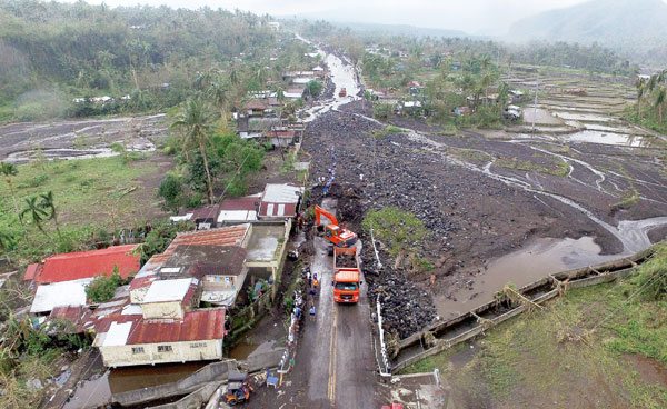 Devastated Aerial photo shows a road filled with debris in Tabaco, Albay province on December 27, 2016. At least seven were people are dead and 18 others missing after Typhoon ‘Nina’ lashed the Philippines over the Christmas holidays. AFP PHOTO