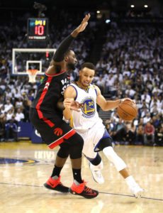 Stephen Curry No.30 of the Golden State Warriors tries to dribble past Patrick Patterson No.54 of the Toronto Raptors at ORACLE Arena on Thursday in Oakland, California.  AFP PHOTO 