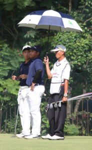 Yuto Katsuragawa (left) and Carl Corpus wait for their turn to putt on No. 3.   CONTRIBUTED PHOTO 