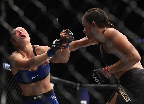 Amanda Nunes of Brazil punches Ronda Rousey in their UFC women's bantamweight championship bout during the UFC 207 event on Saturday in Las Vegas, Nevada.  AFP PHOTOS