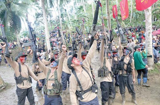 Members of the New People’s Army’s Melito Glor Command mark the 48th anniversary of the founding of the Communist Party of the Philippines in the mountains of Sierra Madre on Wednesday. Communist rebels are refusing to sign a bilateral ceasefire deal without liberty for more than 400 so-called ‘political detainees.’ PHOTO BY RENE DILAN