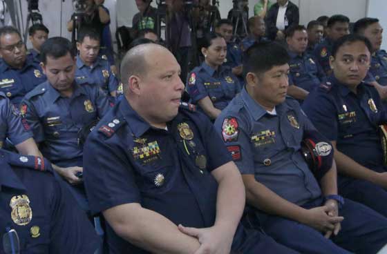 GETTING STARTED Region 8 police chief Marvin Marcos (foreground) of the Criminal Investigation and Detection Group and other policemen attend a preliminary hearing on Tuesday at the Department of Justice in Manila on the killing of Mayor Rolando Espinosa of Albuera, Leyte, and another inmate last November at a jail in the province. PHOTO BY BOB DUNGO