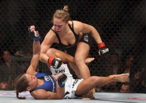 Ronda Rousey hits Liz Carmouche during their UFC Bantamweight Title fight at Honda Center on February 23, 2013 in Anaheim, California.   AFP PHOTO 