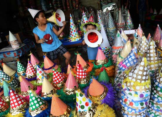 Children toot horns at a warehouse in Manila. The horns await delivery to retailers ahead of the holidays. PHOTO BY RENE H. DILAN