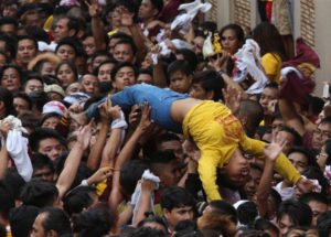 IN GOOD HANDS A Nazarene devotee who fainted during the annual procession is carried to a first aid station. Hundreds of pilgrims who joined the Traslacion were treated by medical staff and personnel of the Philippine Red Cross. PHOTO BY RENE DILAN