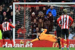 Sunderland’s English striker Jermain Defoe (left) beats Liverpool’s Belgian goalkeeper Simon Mignolet from the penalty spot as Sunderland make it 1-1 during the English Premier League football match between Sunderland and Liverpool at the Stadium of Light in Sunderland, north-east England on January 2. AFP PHOTO