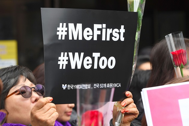 South Korean demonstrators hold banners during  a rally on International Women's Day 