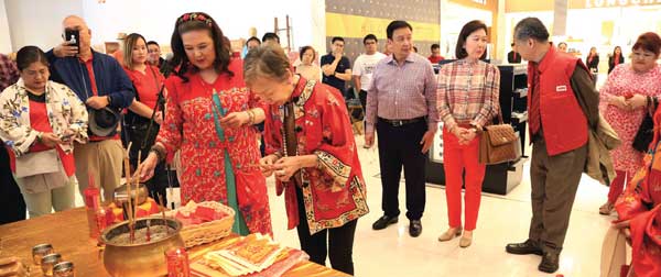 Guests take turns to make their wishes for Chinese New Year — and before the shopping commences.