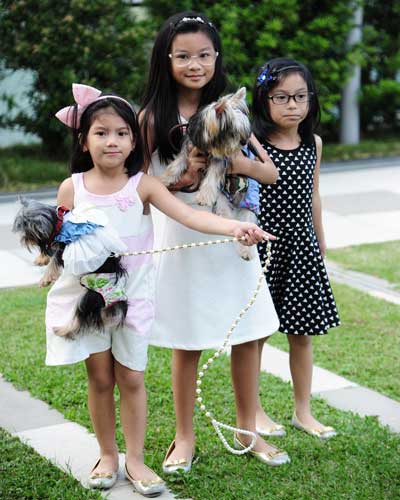 Yasha, Caela and Julia Manlogon with Yorkies Bailey and Hailey.