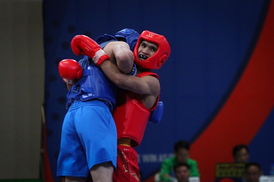 Clemente Pabatang (red) wins his quarterfinals fight against Chee Chong Teh (blue) of Malaysia in Wushu Sanda at the World Trade Center, Sunday afternoon. PHOTO BY J. GERARD SEGUIA