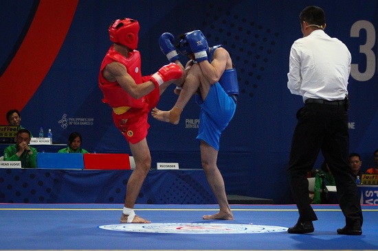 Clemente Pabatang (red) wins his quarterfinals fight against Chee Chong Teh (blue) of Malaysia in Wushu Sanda at the World Trade Center, Sunday afternoon. PHOTO BY J. GERARD SEGUIA