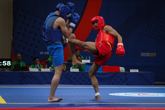 Clemente Pabatang (red) wins his quarterfinals fight against Chee Chong Teh (blue) of Malaysia in Wushu Sanda at the World Trade Center, Sunday afternoon. PHOTO BY J. GERARD SEGUIA