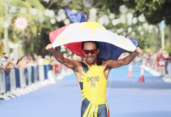 The Philippines' John Leerams Chicano celebrates after winning the gold in the men's triathlon in Subic, Zambales on Sunday. Kim Remolino bagged the silver medal in the same event. PHOTO BY ROGER RAÑADA