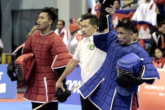 Villardo Cunamay (in blue) hits his Cambodian opponent Yong Mengly  to win the gold medal in Live Stick welterweight division during the 30th Sea Games held in Angeles City. PHOTO BY ROGER RAÑADA