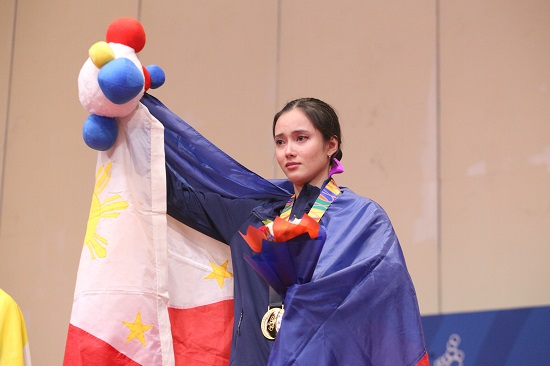 Agatha Wong holds back her tears as she stand in the podium after winning a gold medal for the women’s wushu event at the 30th Southeast Asian Games held at the World Trade Center in Pasay City. PHOTO BY ENRIQUE AGCAOILI