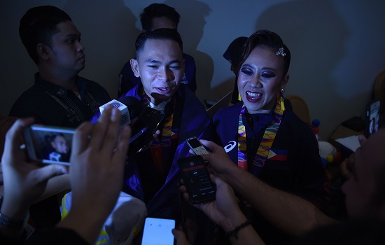 Philippines' Mark Gayon (L) and Joy Renigen (R) looks on as they speak to the media after performing in the dancesport event in the SEA Games (Southeast Asian Games) in Clark, Capas town, Tarlac province north of Manila on December 1, 2019. (Photo by WAKIL KOHSAR / AFP)