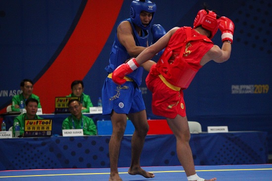 Gideon Fred Padua of the Philippines (red) wins his quarterfinals fight against Jian Hwa Chong (blue) of Indonesia in Wushu Sanda at the World Trade Center, Sunday afternoon. PHOTO BY J. GERARD SEGUIA