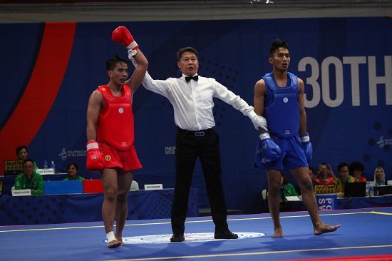 Gideon Fred Padua of the Philippines (red) wins his quarterfinals fight against Jian Hwa Chong (blue) of Indonesia in Wushu Sanda at the World Trade Center, Sunday afternoon. PHOTO BY J. GERARD SEGUIA