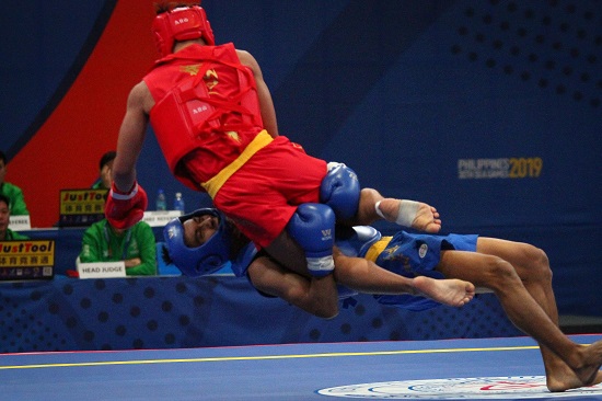 Gideon Fred Padua of the Philippines (red) wins his quarterfinals fight against Jian Hwa Chong (blue) of Indonesia in Wushu Sanda at the World Trade Center, Sunday afternoon. PHOTO BY J. GERARD SEGUIA