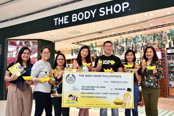Yellow Boat of Hope Foundation Co-founder Anton Lim and Grants and Partnerships Officer Ella Rodriguez receive the funds raised from The Body Shop team.