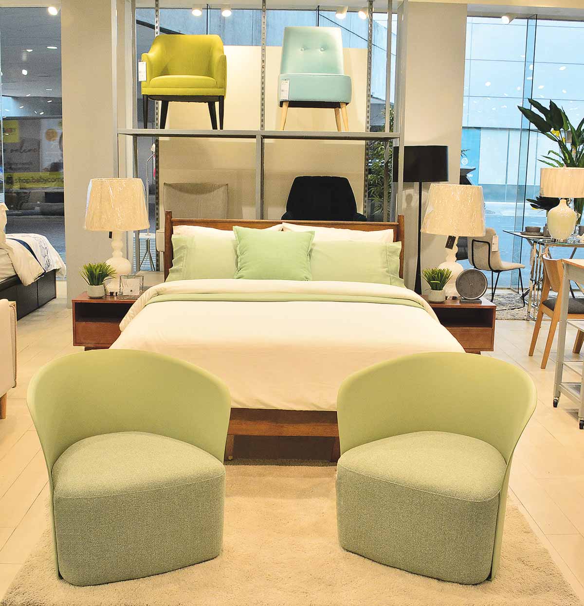 Freshen small spaces with
Scandinavian styled pieces
— white furniture in light
wood mixed with pastelcolored
pieces like these
Solenn Bedframe and Fia
Accent chairs.